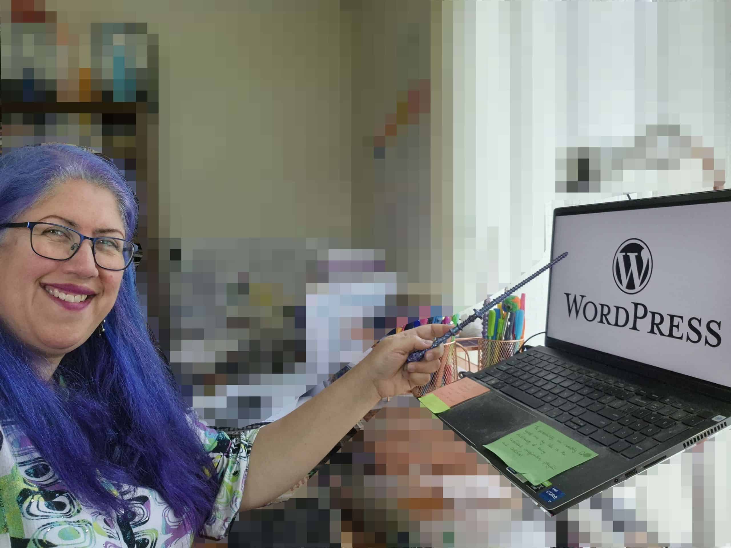 Karen Leslie pointing to laptop with WordPress logo on it