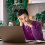 worried woman at laptop
